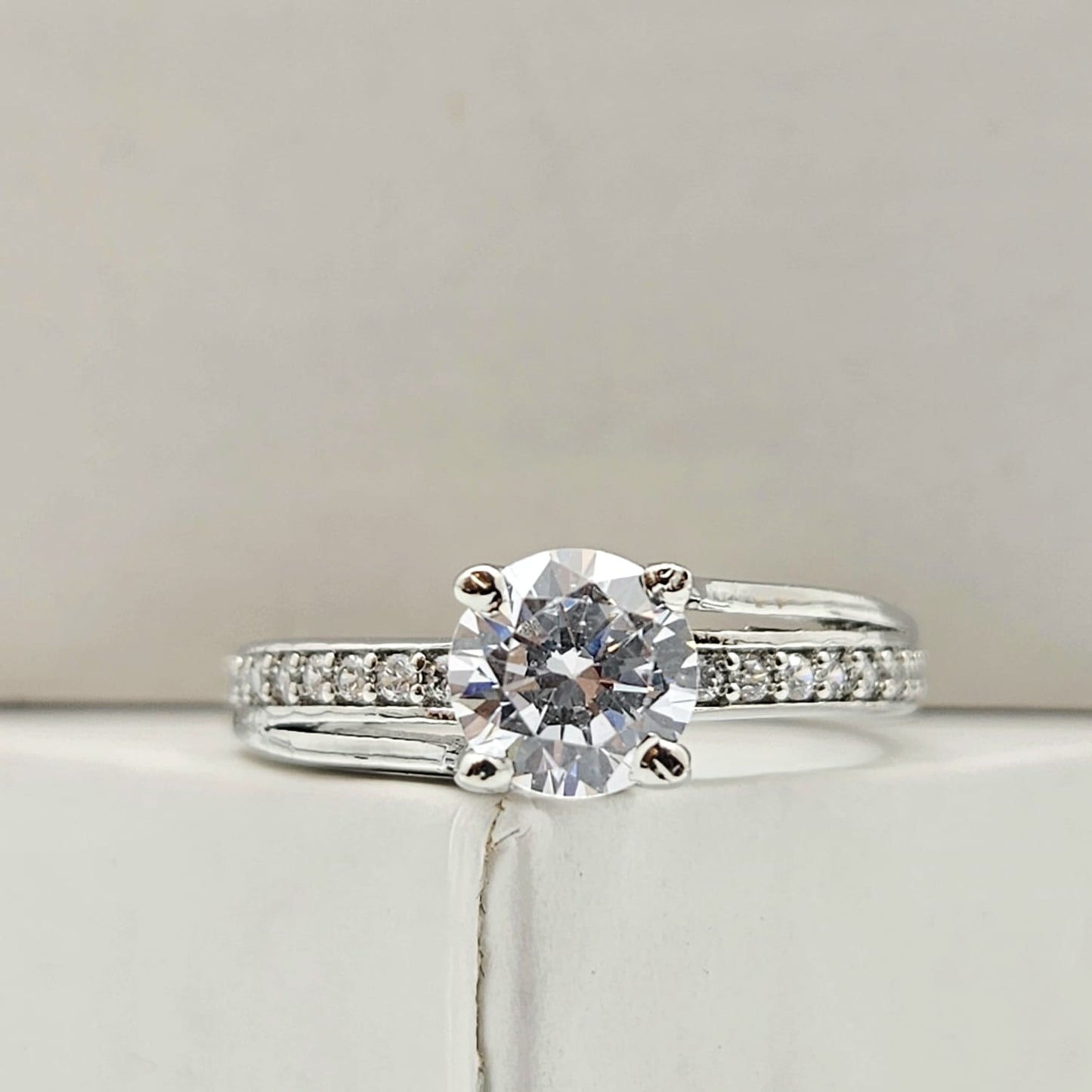 Round-Cut Solitaire Engagement Ring with a Channel-Set Band