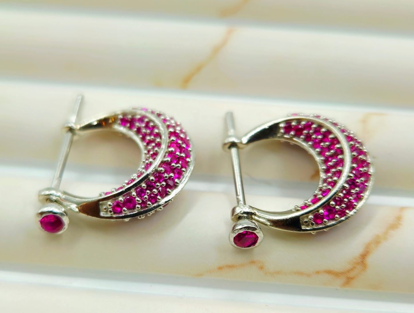 Silver Pave Ruby Huggie Hoop Earrings.