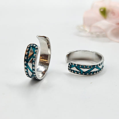 A turquoise tribal pattern toe rings