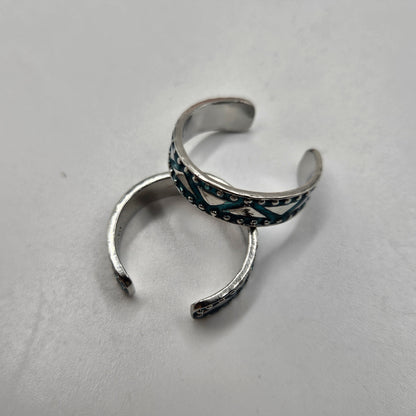 A turquoise tribal pattern toe rings