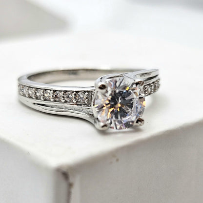 Round-Cut Solitaire Engagement Ring with a Channel-Set Band