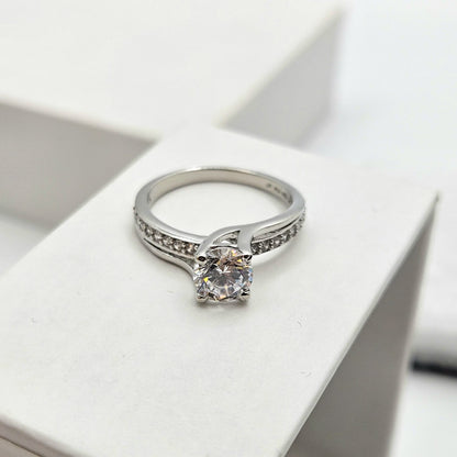Round-Cut Solitaire Engagement Ring with a Channel-Set Band