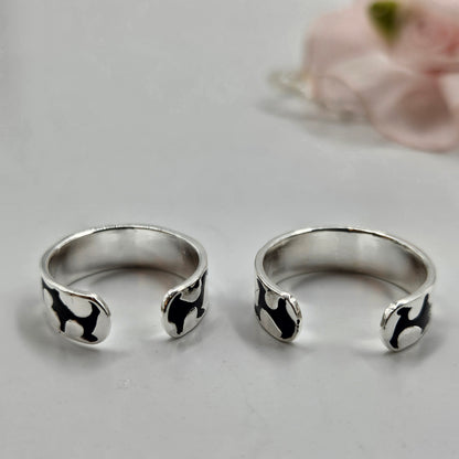 Sterling silver toe rings with a black abstract pattern