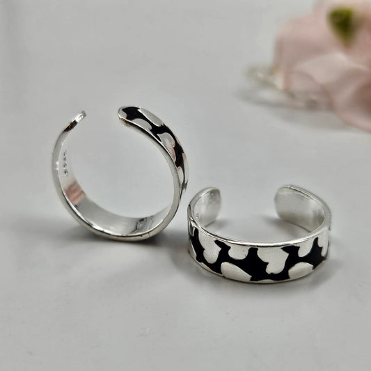 Sterling silver toe rings with a black abstract pattern